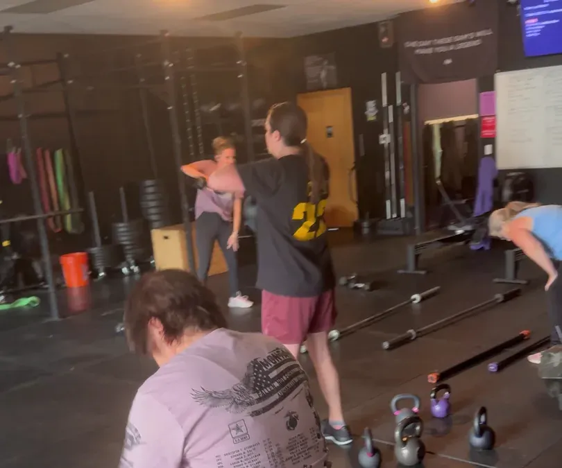 Members working through a fight-conditioning class on the gym floor