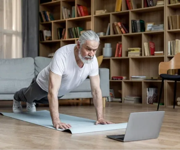 A member following a Knockout workout video at home