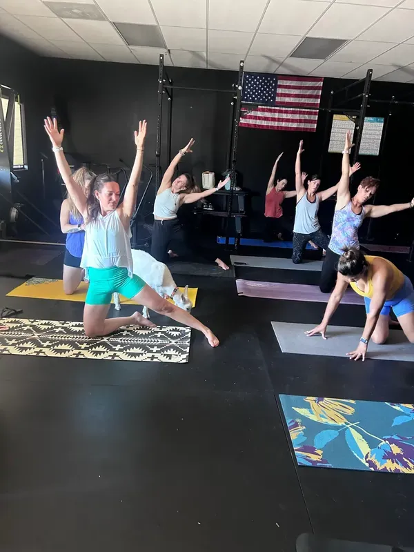 Members mid-flow in a yoga class at the gym