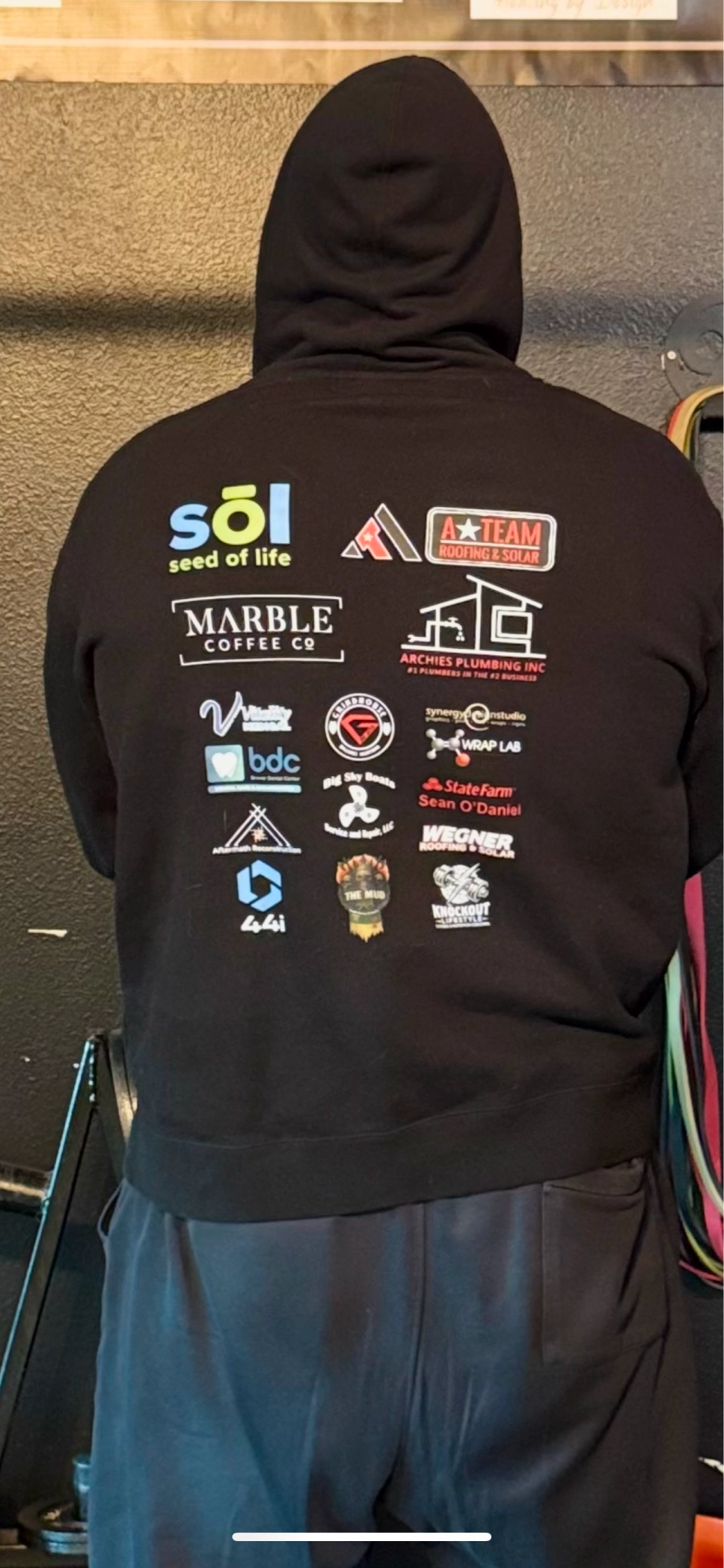 The back of a Knockout hoodie printed with sponsor logos