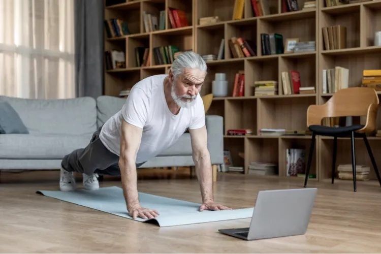 Member following a Knockout Lifestyle workout at home with a laptop